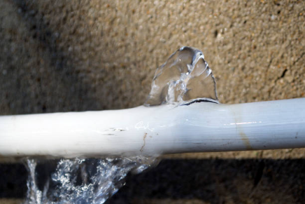 image of busted pipe with frozen water coming out of it