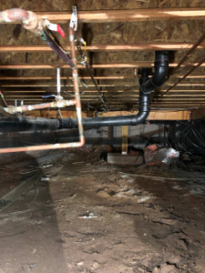 image of pipes in crawlspace under a home